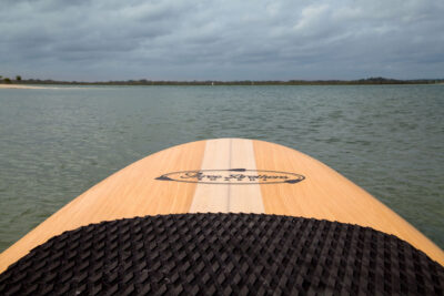 three brothers boards wood paddle boards blondie nose heading toward beach
