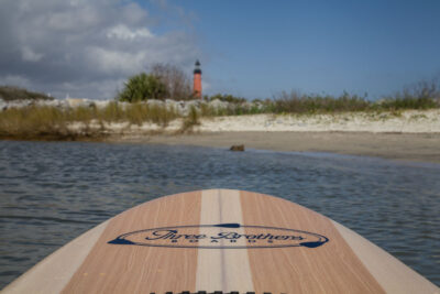 three brothers boards wood paddle boards woodrow heading to beach