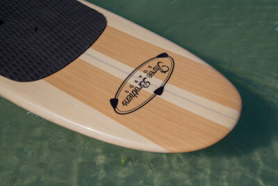 three brothers boards wood paddle boards woodrow nose detail on the water